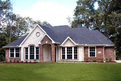 Example of a mid-sized classic multicolored two-story mixed siding gable roof design in Houston