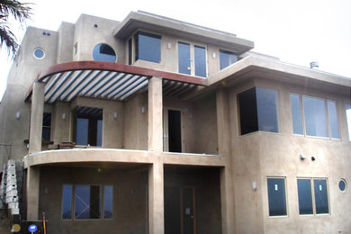 Inspiration for a large contemporary beige three-story concrete exterior home remodel in San Diego