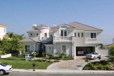 Inspiration for a large timeless white two-story exterior home remodel in Los Angeles