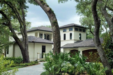 Inspiration for a large timeless beige three-story stucco exterior home remodel in Jacksonville