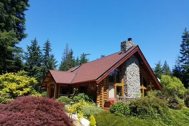 Medium sized and brown rustic bungalow detached house in Seattle with wood cladding, a pitched roof and a shingle roof.