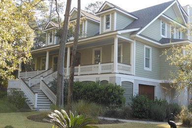 Inspiration for a large contemporary green two-story vinyl exterior home remodel in Charleston