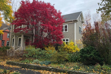 Example of a mid-sized classic gray two-story wood house exterior design in Boston with a hip roof and a shingle roof