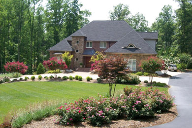 Large elegant brown split-level mixed siding house exterior photo in Charlotte with a hip roof and a shingle roof