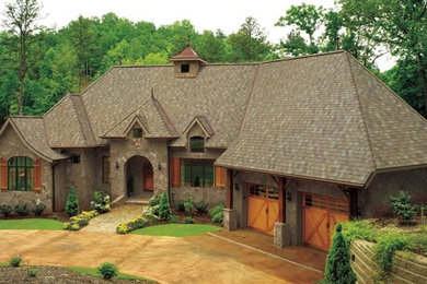 Inspiration for a mid-sized timeless blue one-story stone house exterior remodel in Denver with a hip roof and a shingle roof