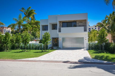 Example of a mid-sized minimalist white two-story stucco exterior home design in Miami