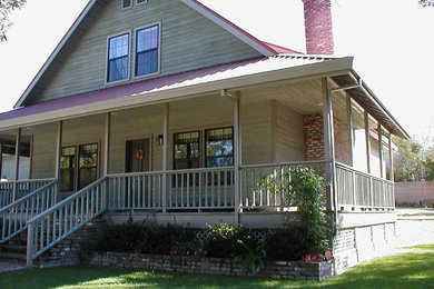 This is an example of a large and brown traditional two floor house exterior in Sacramento with wood cladding.