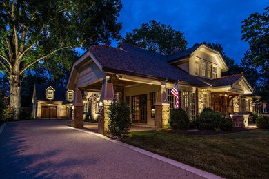 Large craftsman beige two-story stone exterior home idea in Nashville with a shingle roof