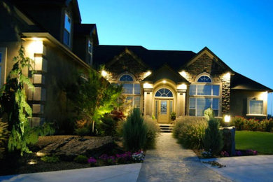 Example of a large brown two-story stone gable roof design in New York