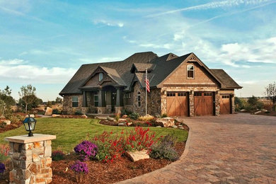 Inspiration for a large craftsman brown two-story stone exterior home remodel in Denver with a shingle roof