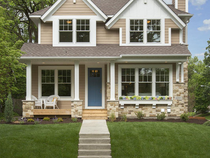Large elegant beige two-story wood exterior home photo