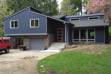 Example of a small transitional blue split-level mixed siding house exterior design in Seattle with a shed roof and a shingle roof