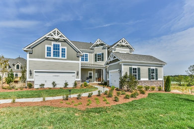 Transitional beige two-story exterior home photo in Charlotte with a gambrel roof
