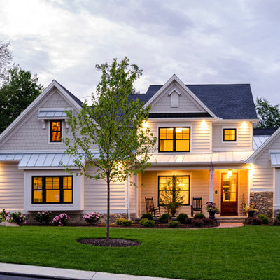 Example of a classic beige two-story concrete fiberboard gable roof design in Other