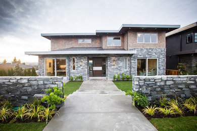 Example of a trendy gray three-story stone exterior home design in Vancouver