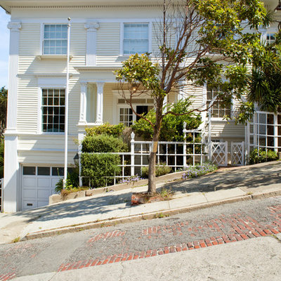 Example of a classic yellow exterior home design in Other