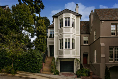 Example of a huge ornate gray three-story concrete house exterior design in San Francisco with a gambrel roof and a shingle roof