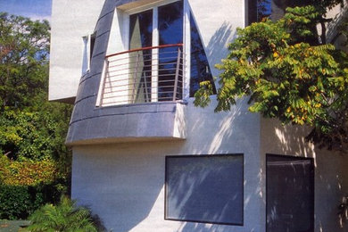 Example of a mid-sized trendy white two-story metal flat roof design in Los Angeles