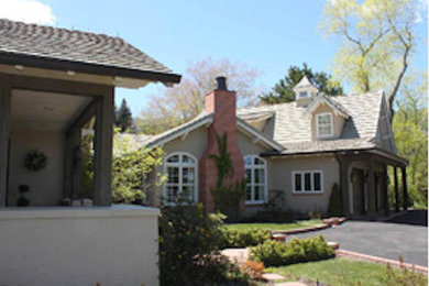 Example of a beige two-story exterior home design in Denver