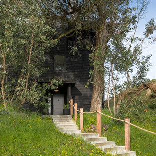 Inspiration for a mid-sized coastal black three-story wood house exterior remodel in Other