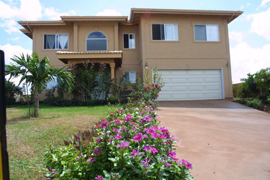 Medium sized and beige traditional two floor render detached house in Hawaii with a tiled roof.