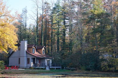 Modelo de fachada de casa gris de estilo americano de tamaño medio con revestimiento de madera, tejado a dos aguas y tejado de teja de madera