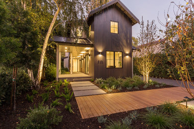 Inspiration for a farmhouse two-story mixed siding house exterior remodel in San Francisco with a metal roof