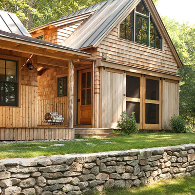 Inspiration for a rustic wood exterior home remodel in Portland Maine with a metal roof