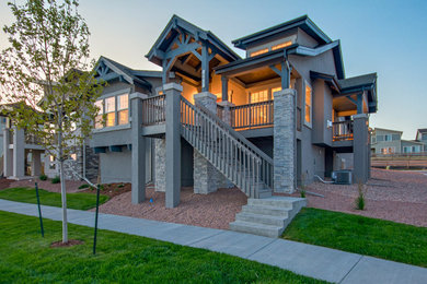 Mid-sized arts and crafts gray stucco house exterior photo in Denver with a shingle roof