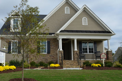 Example of a mid-sized classic brown two-story mixed siding exterior home design in Raleigh with a shingle roof