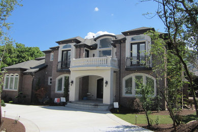 Example of a large classic beige two-story mixed siding exterior home design in Salt Lake City