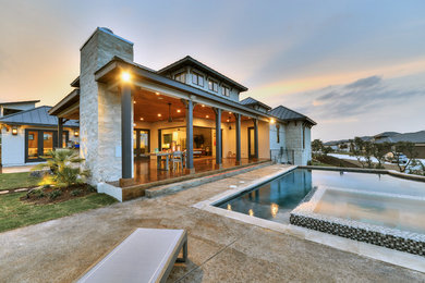 Inspiration for a large transitional gray two-story stone exterior home remodel in Austin