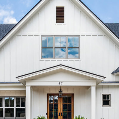 Inspiration for a mid-sized farmhouse white two-story concrete fiberboard exterior home remodel in Other with a shingle roof