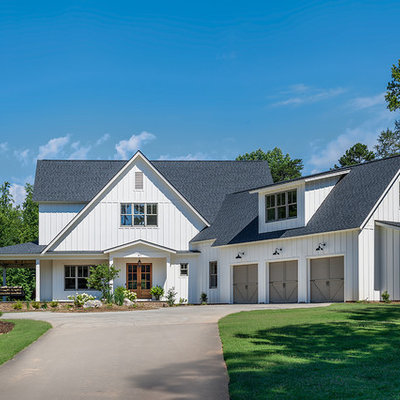 Mid-sized cottage white two-story concrete fiberboard exterior home photo in Other with a shingle roof