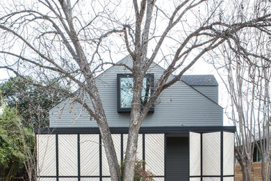 Example of a mid-sized trendy gray two-story wood exterior home design in Austin