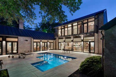 Large minimalist beige two-story brick exterior home photo in Dallas