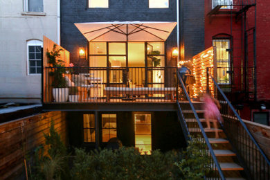 Mid-sized contemporary gray three-story brick exterior home idea in New York