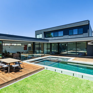 Design ideas for a mid-sized contemporary two-storey grey house exterior in Melbourne with mixed siding and a flat roof.