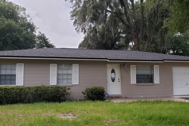 House exterior idea in Orlando with a shingle roof and a gray roof