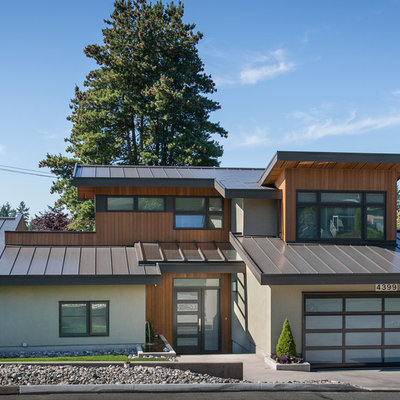 Mid-sized contemporary multicolored two-story mixed siding exterior home idea in Vancouver with a metal roof