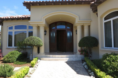 Inspiration for a large mediterranean beige two-story adobe exterior home remodel in San Francisco with a tile roof