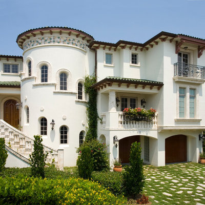 Mid-sized tuscan white three-story stucco exterior home photo in Tampa with a tile roof