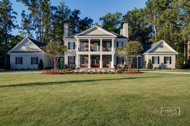 Huge transitional beige two-story stucco exterior home idea in Charlotte