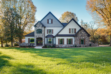 Arts and crafts beige stucco exterior home photo in Charlotte