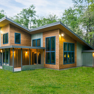Large contemporary multicolored two-story mixed siding house exterior idea in Detroit with a shed roof