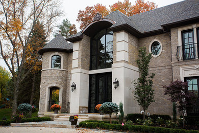 Design ideas for an expansive and brown traditional two floor brick house exterior in Detroit.