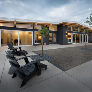 Mid-sized mid-century modern gray one-story wood house exterior photo in Other