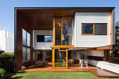 Photo of a white contemporary two floor house exterior in Brisbane with mixed cladding and a flat roof.
