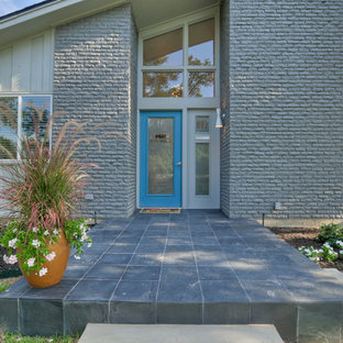 Inspiration for a mid-sized mid-century modern gray one-story brick gable roof remodel in Dallas