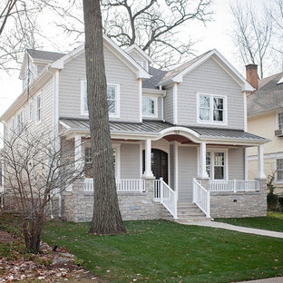 Large transitional gray two-story concrete fiberboard exterior home photo in Chicago with a mixed material roof